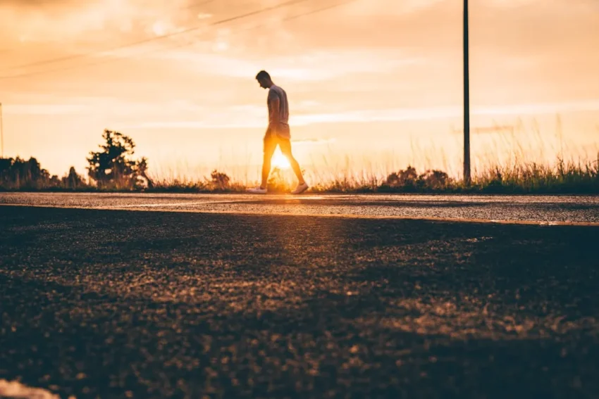 A sunrise illuminating a winding pathway, symbolizing process over outcome mindset