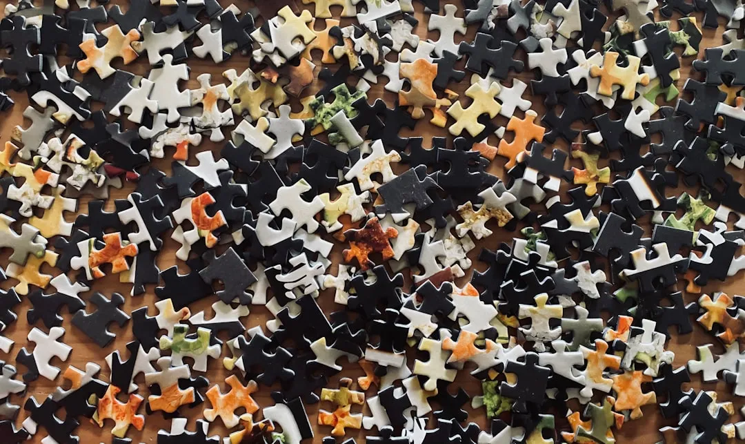 Diverse hands joining puzzle pieces concept for creative problem solving