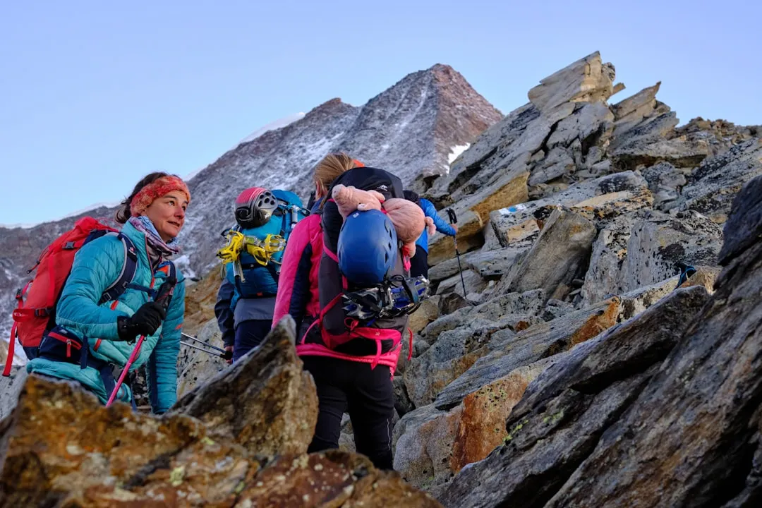 Supportive team climbing mountain to Overcome Self-Limiting Beliefs together