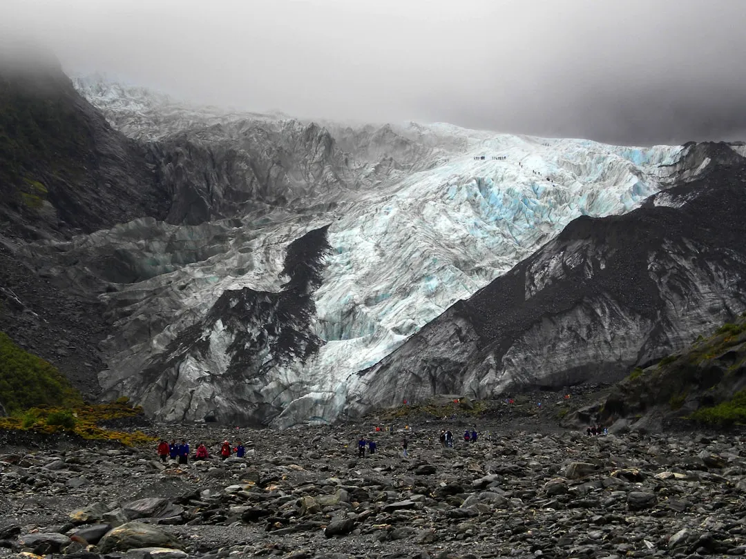 Person climbing a mountain embodying the proactive mindset approach to challenges