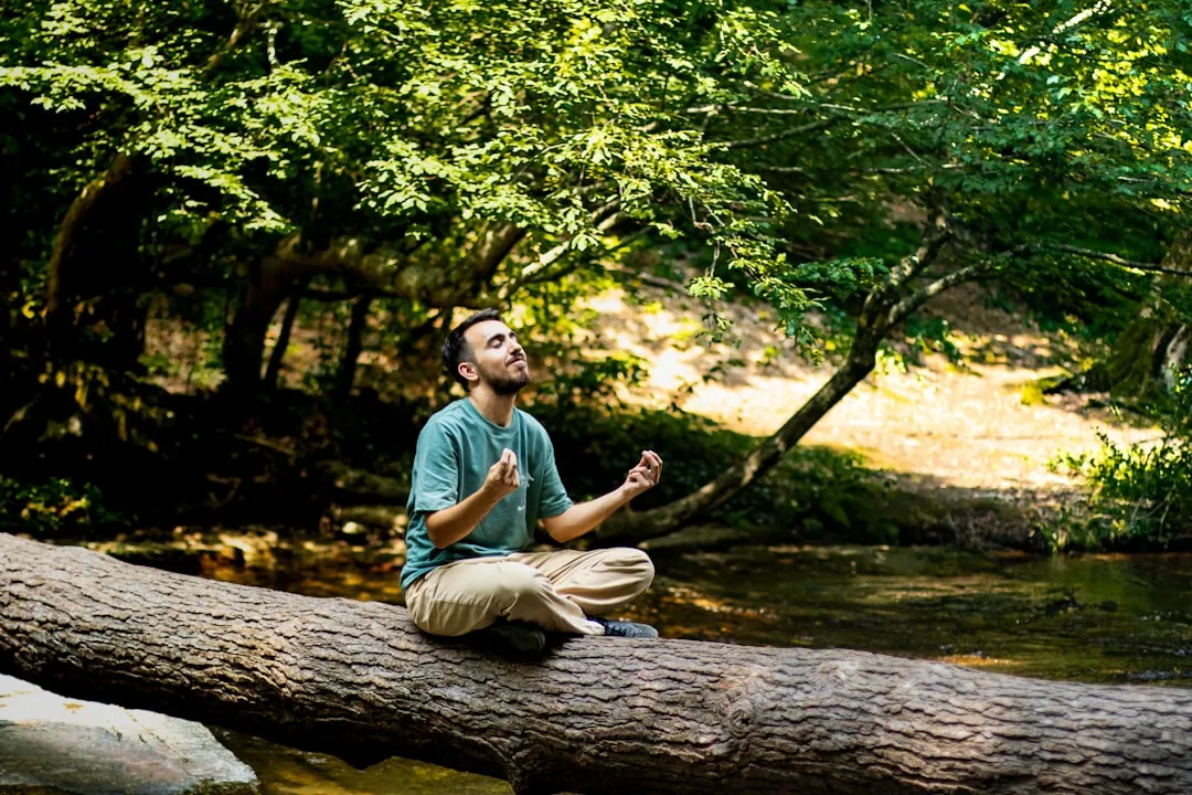 Person meditating in peaceful nature representing Emotional Freedom and acceptance